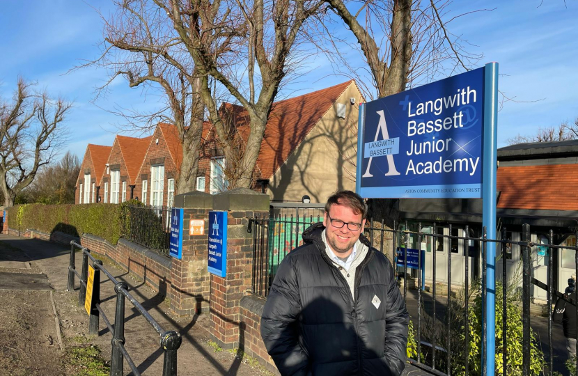Langwith Bassett Academy standing outside by sign